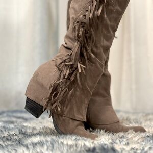 Fringed heeled boots.